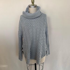 Cozy gray cable knit with faux leather button detailing.